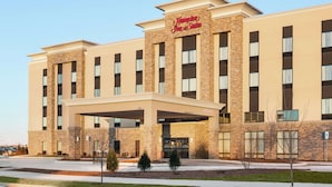 A Hampton Inn & Suites building with a brick facade, large windows, and a covered entrance. - Hampton Inn & Suites Minooka (Minooka)