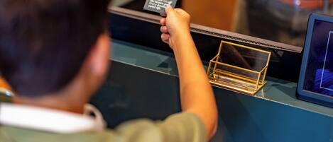 A person interacting with a digital kiosk, possibly for check-in or information.