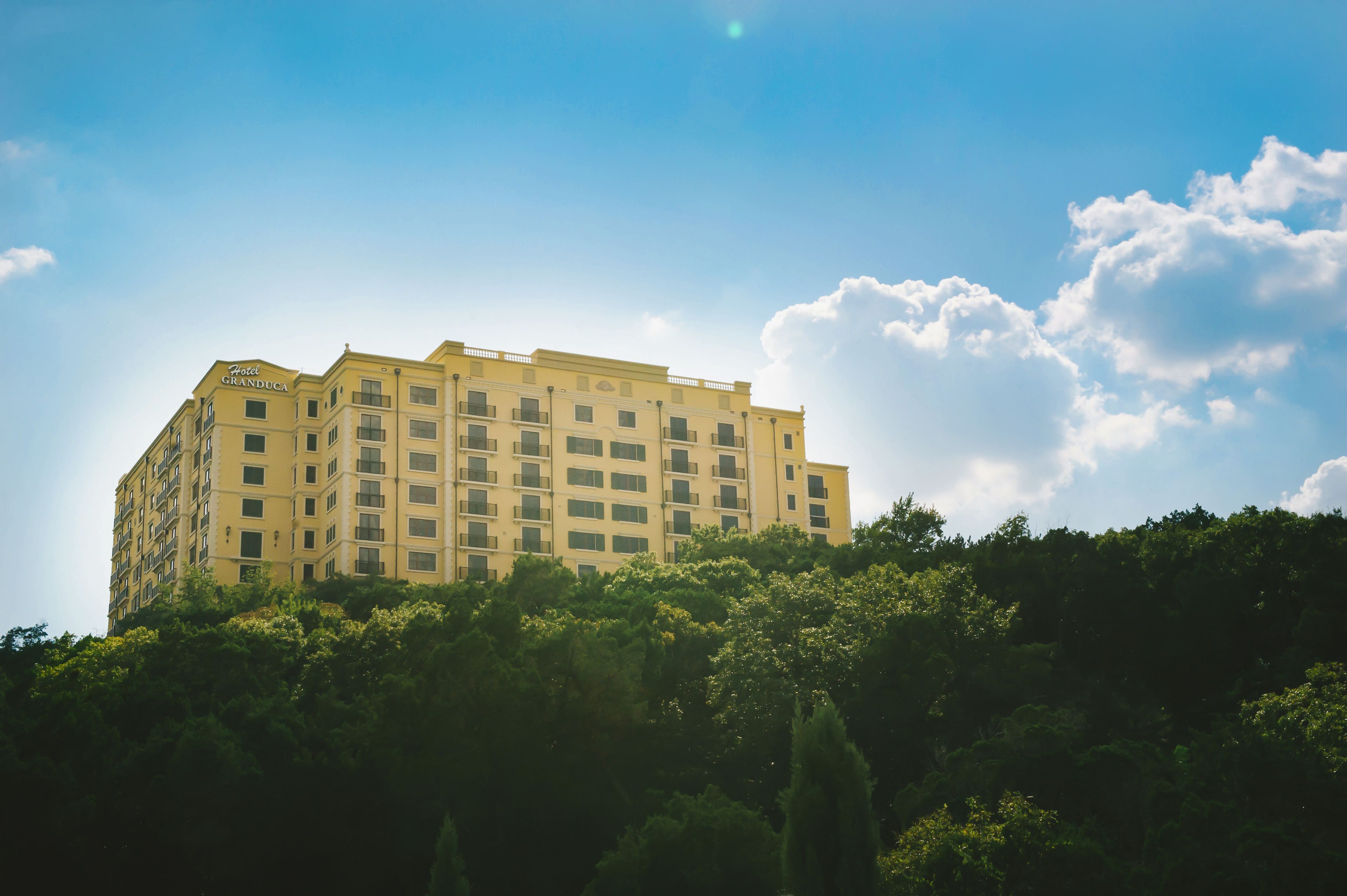 A multi-story hotel with a flat facade, balconies, and a sign reading "Hotel Granduca."