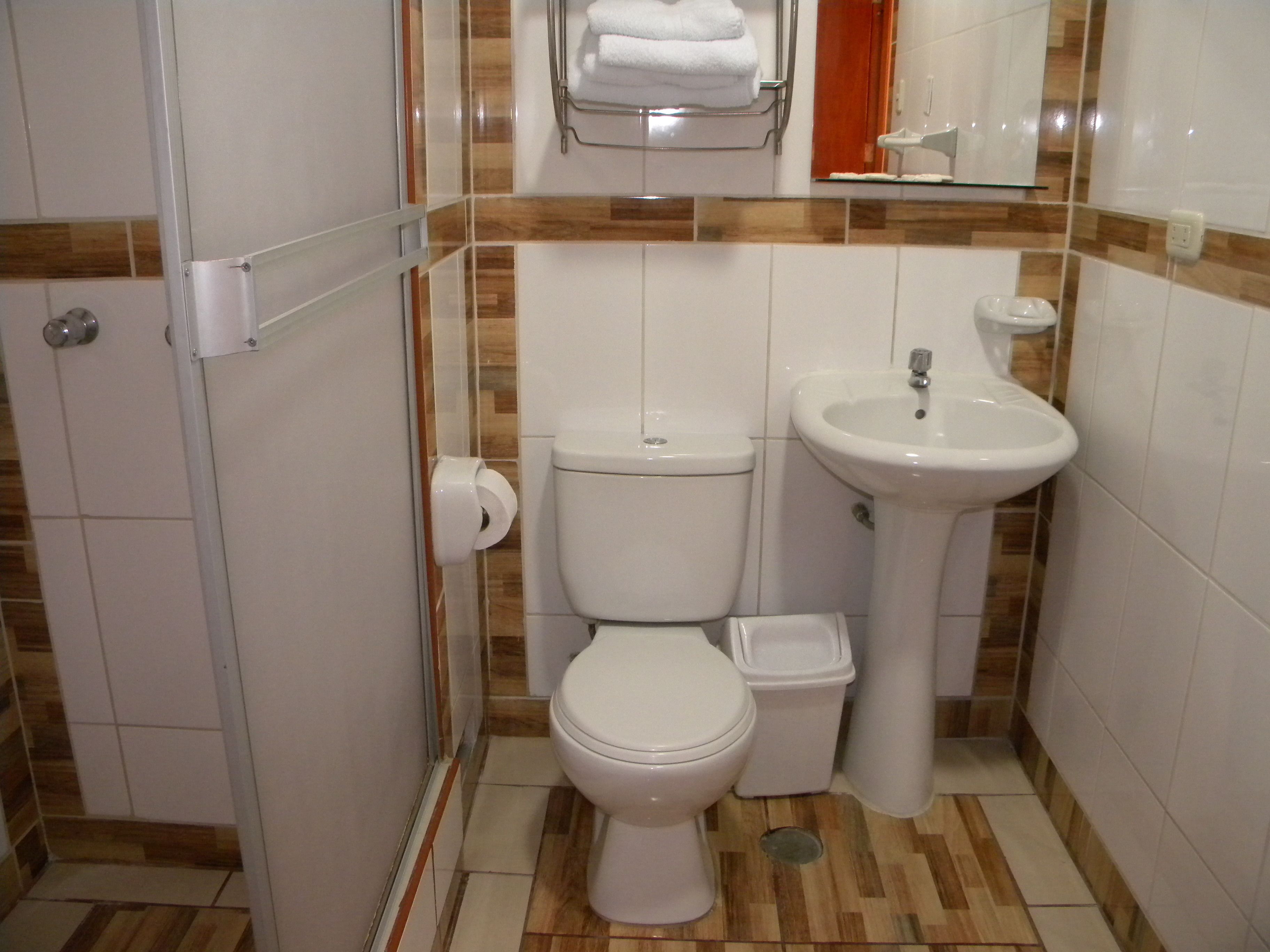 A compact bathroom with a toilet, bidet, and sink.
