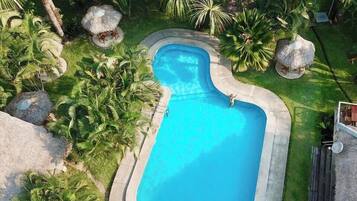Surrounded by lush greenery, this pool offers a serene escape.