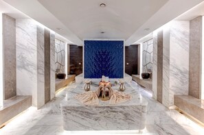 A luxurious bathroom with marble floors, a central sink, and a blue decorative wall. - DoubleTree by Hilton Hotel Istanbul - Piyalepasa (Istanbul)
