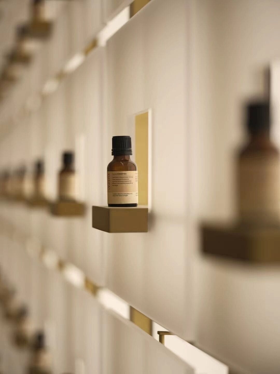 A row of bottles on a wall with a uniform design.