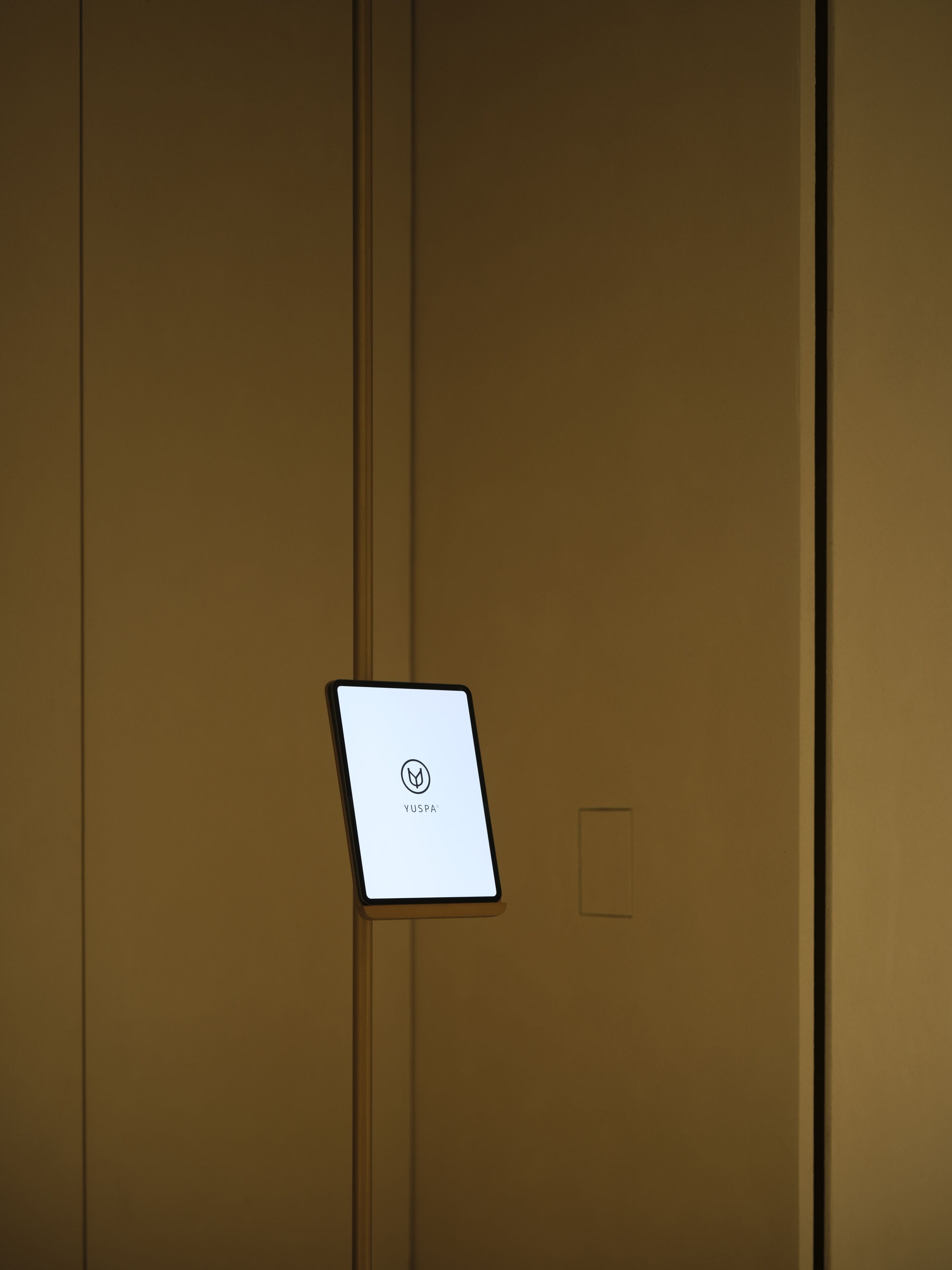 A closed door with a YUSPA® sign on a small screen.