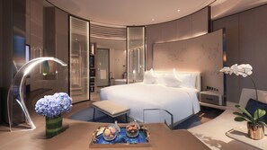 A modern hotel room with a large bed, a vanity with a mirror, a seating area, and a view of the hallway. - InterContinental Beijing Sanlitun by IHG (Beijing)