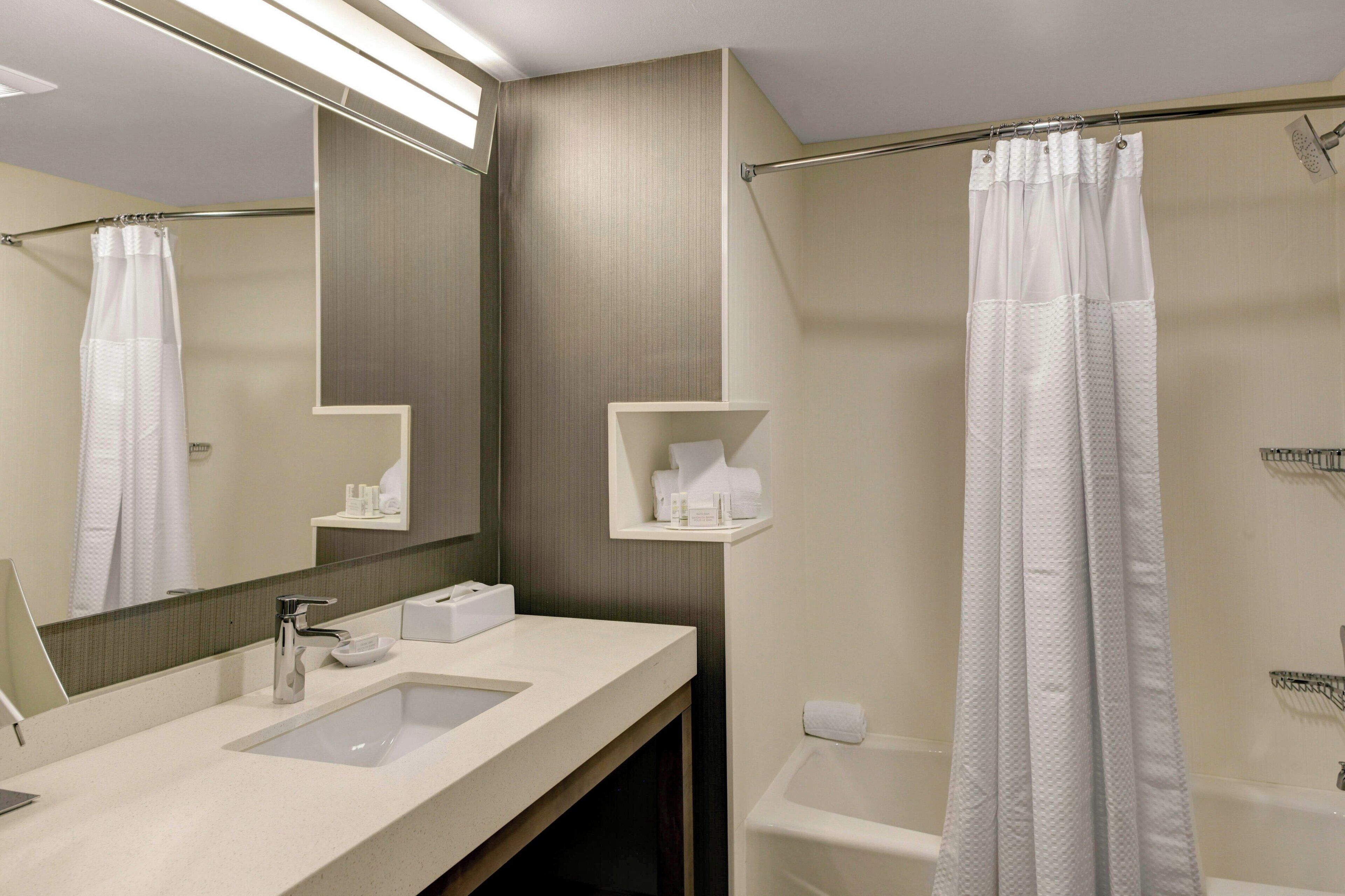 room, 2 queen beds (two queen) | bathroom | shower, free toiletries, hair dryer, towels