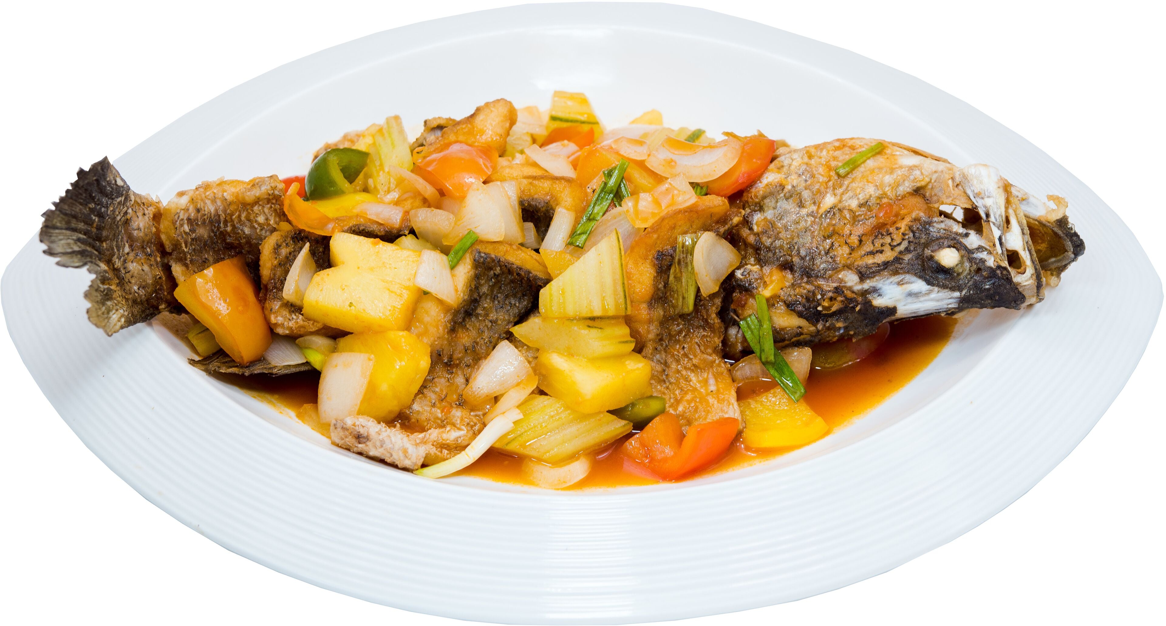 A whole fish with vegetables on a white plate.