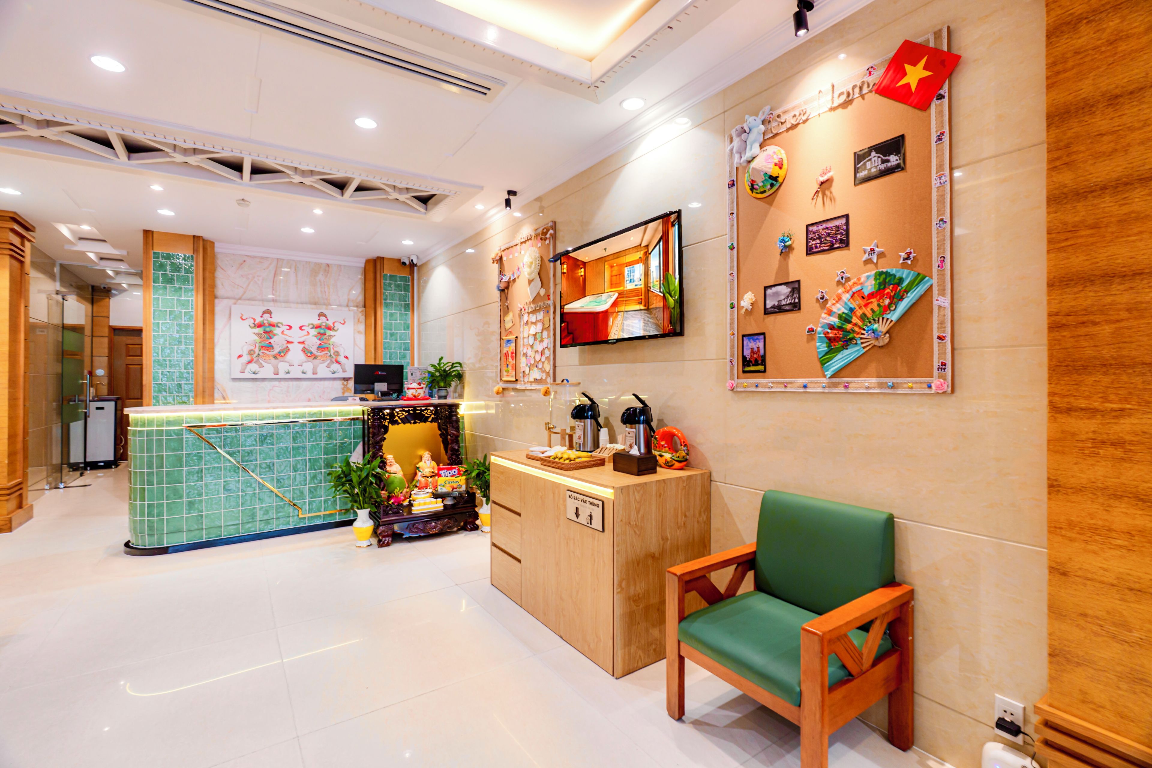 A reception area with a counter, a green chair, and a wall decorated with various items including a flag.