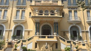 A multi-story building with a central entrance, balconies, and a statue. - The Noble Swan Saigon (Ho Chi Minh City)