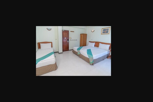 A hotel room with two single beds, a wardrobe, and a door. - New Siam II (Bangkok)