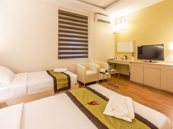 Deluxe kamer | Een minibar, een kluis op de kamer, een bureau, verduisterende gordijnen