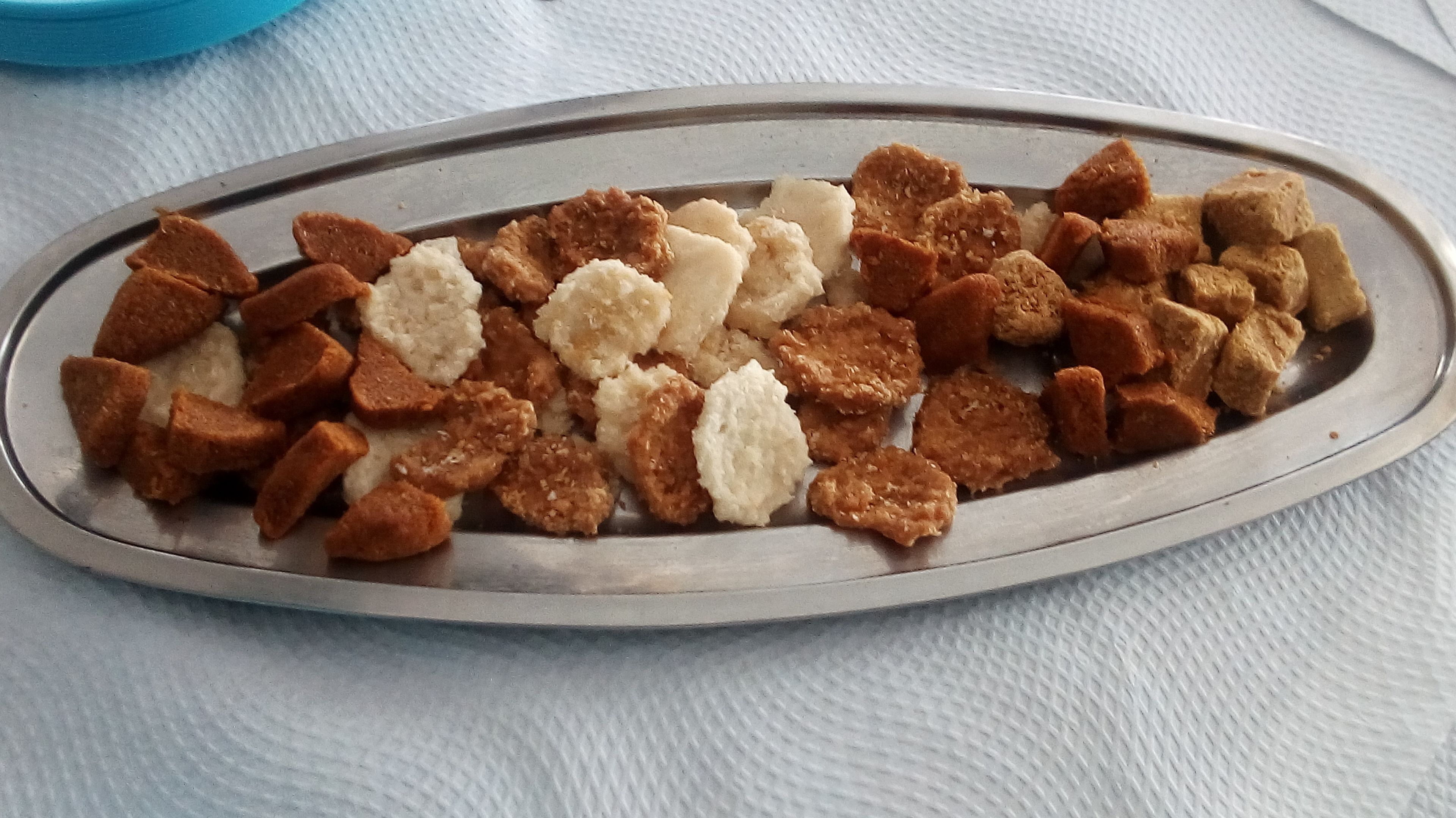 A metal tray with assorted food items.