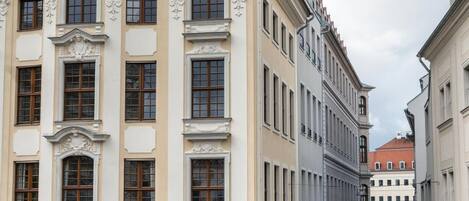 A historic building with ornate architectural details, including a prominent sign for 'Vapiano' restaurant.