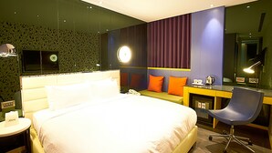 A modern hotel room with a large bed, a desk, a chair, and a mirror. - Royal Group Hotel Bo Ai Branch (Kaohsiung)