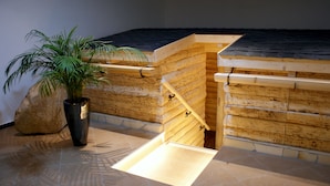 A wooden staircase leading to a loft area with a sloped ceiling.