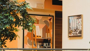 A restaurant interior with seating arrangements, a menu board, and a framed picture on the wall. - Corso Boutique Luxury Rooms (Rome)