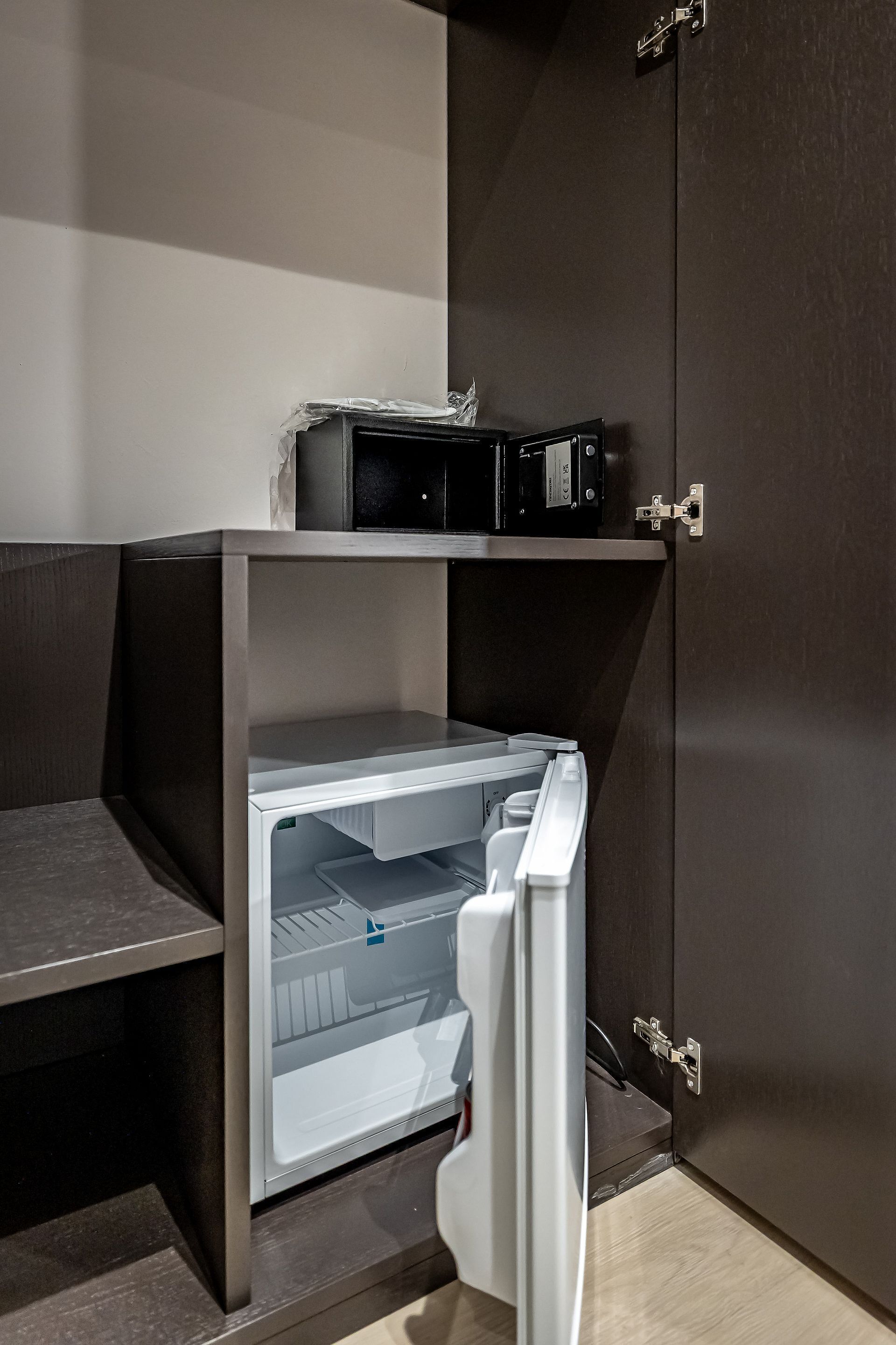 A compact kitchenette with a microwave, a refrigerator, and a small countertop.