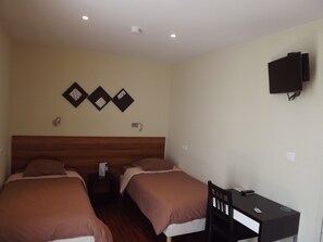 A hotel room with two beds, a desk, and a TV mounted on the wall. - CIST Domaine d'Ariane (Mondonville)