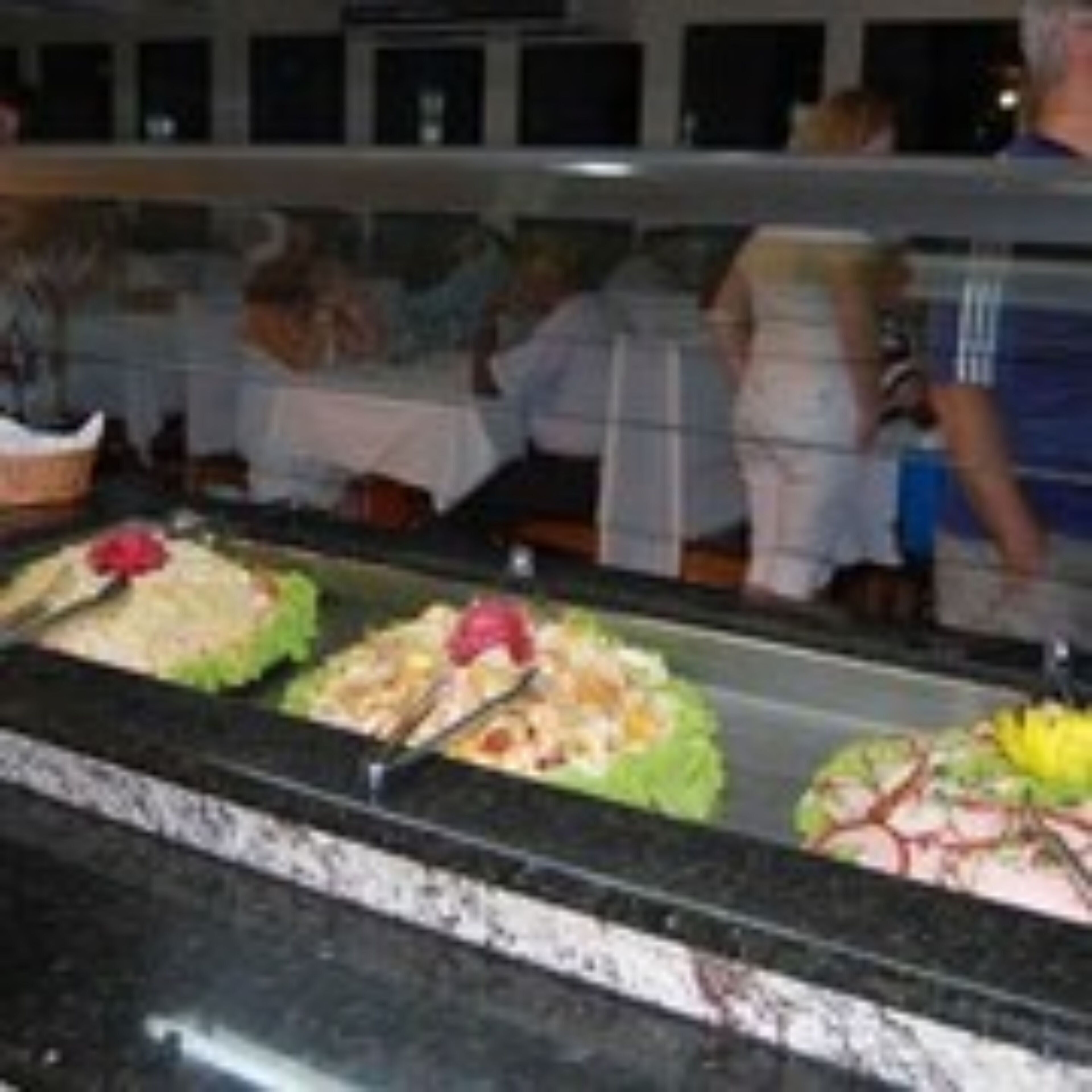 A buffet area with various food items displayed in glass containers.
