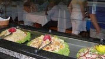A buffet area with various food items displayed in glass containers.