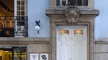 Stunning building facade with a grand entrance featuring a double door and balcony.