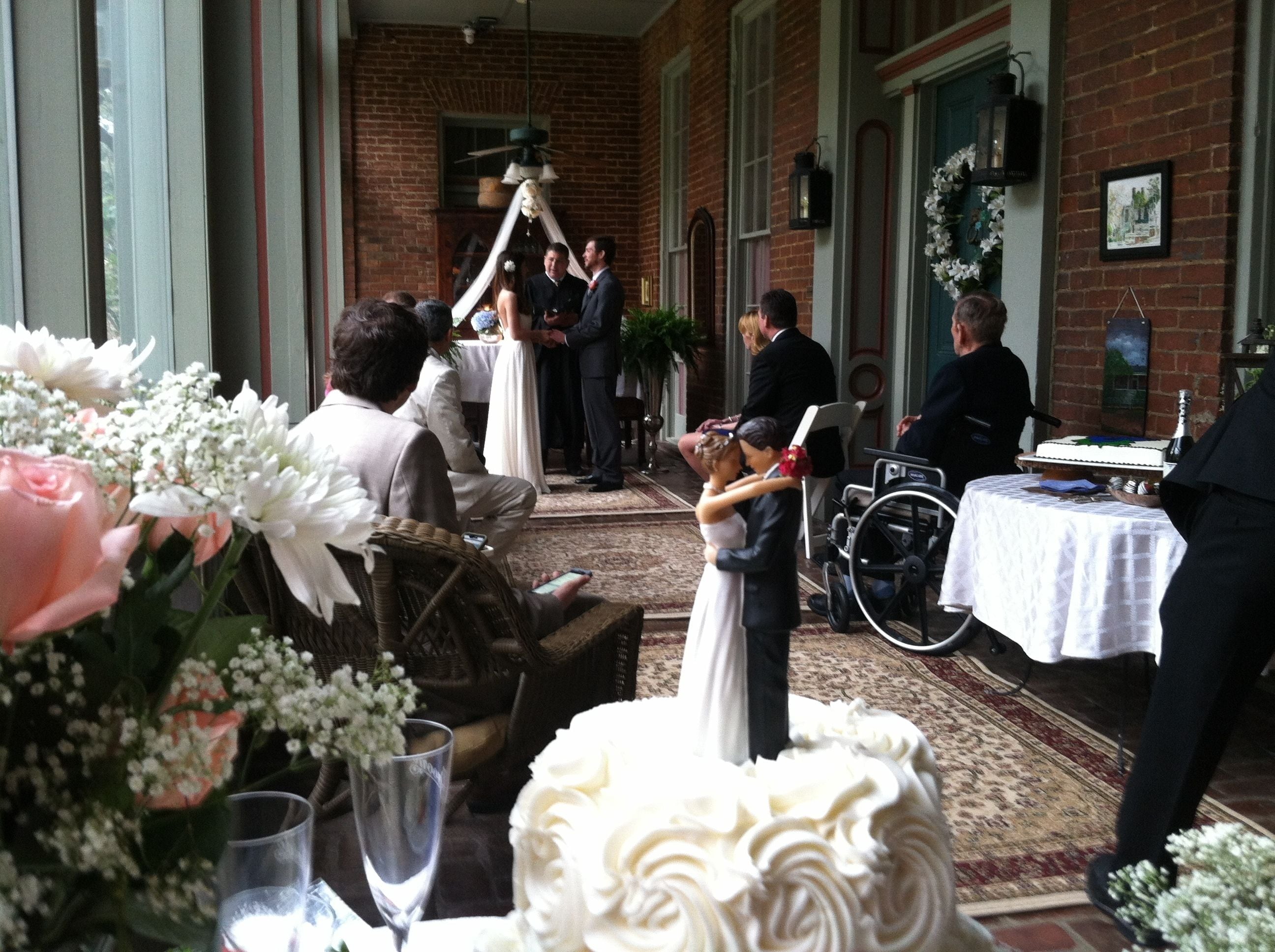 A wedding reception with a bride and groom in the center, surrounded by guests.