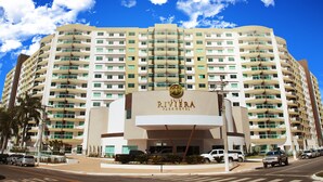 A multi-story hotel with a prominent sign reading "RIVIERA PARKING".