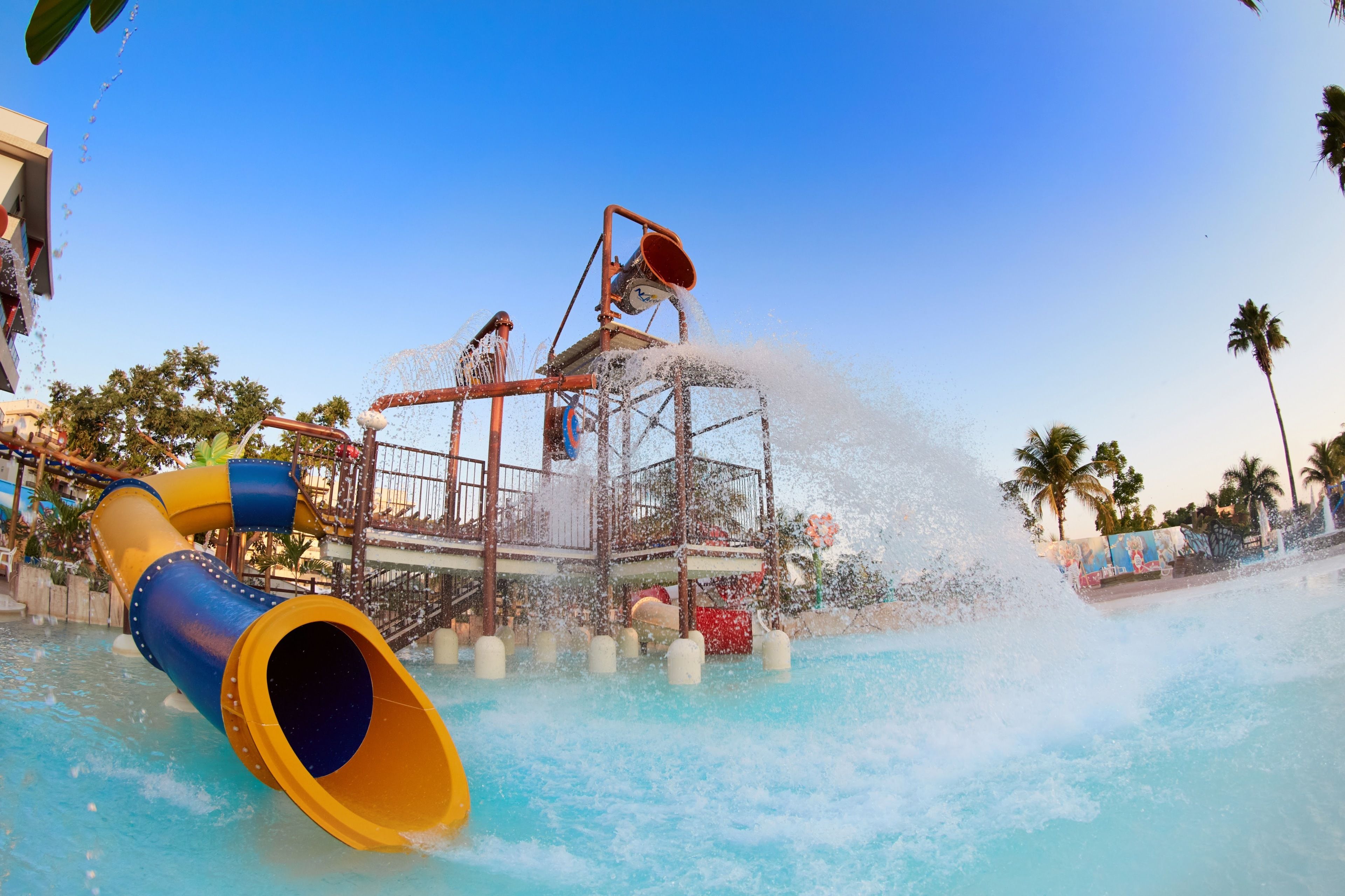 A water park with a large water slide and a water fountain.
