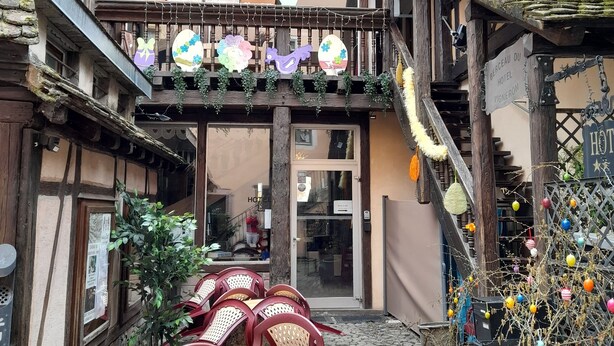 A traditional European building with a balcony decorated with Easter-themed ornaments.