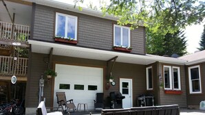 A two-story house with a garage, a balcony, and a patio area with outdoor furniture. - Bed & Breakfast Du Repos (Saint Quentin)