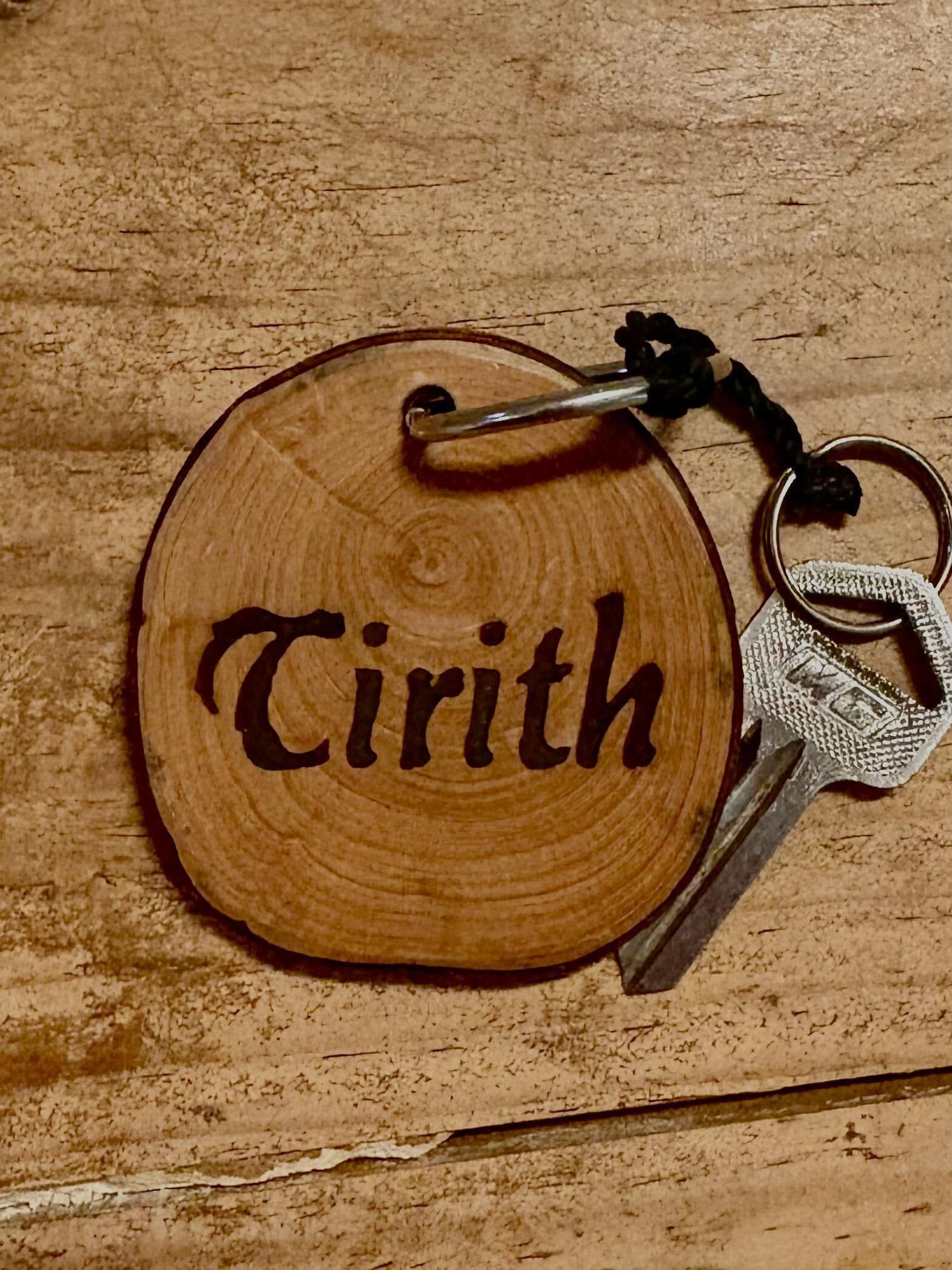 A wooden keychain with the name "Cirith" engraved on it.
