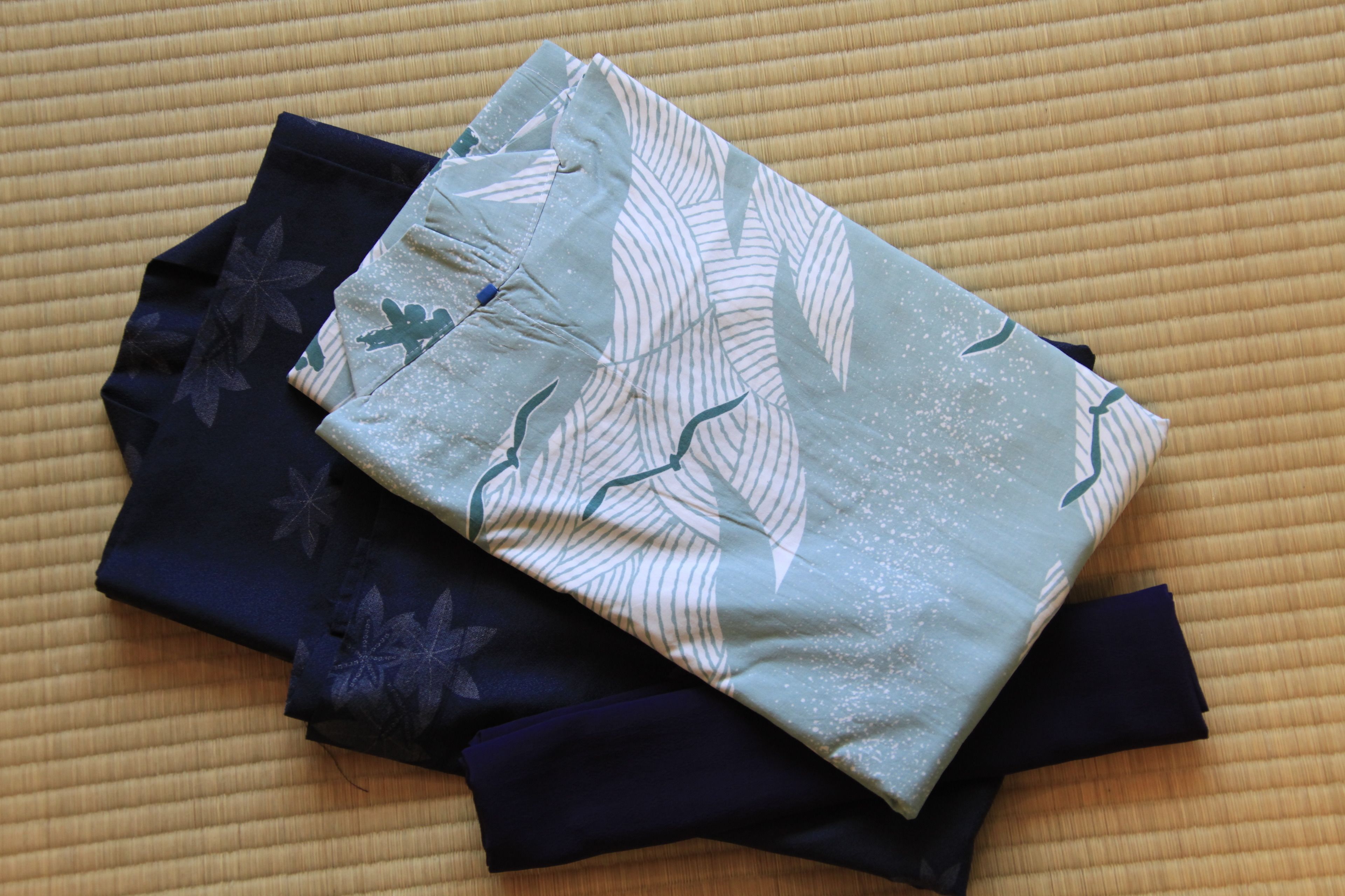 A folded fabric with a leaf pattern on a textured surface.