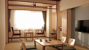 A traditional Japanese-style room with tatami flooring, low tables, and chairs. - Heiseikan Kaiyotei (Hakodate)