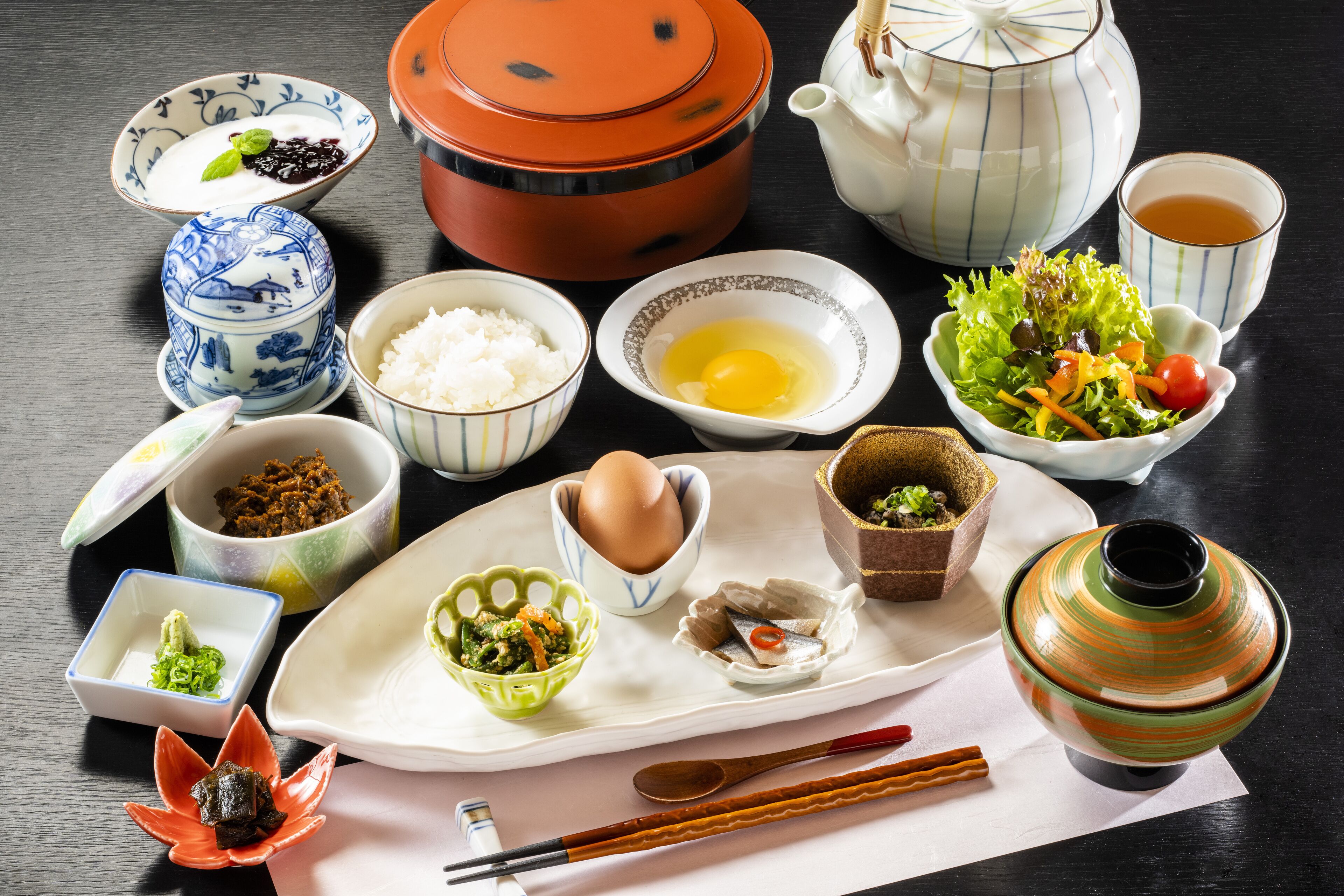 A traditional Japanese meal setup with various dishes and utensils.