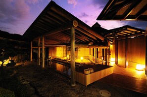 A traditional Japanese-style building with a wooden exterior and a stone pathway leading to a wooden deck. - Kifu No Sato (Mimasaka)