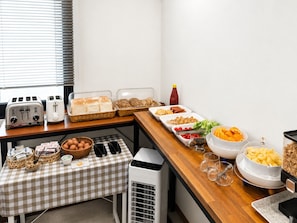 A buffet setup with various food items and a toaster. - Haerium Hotel (Busan)