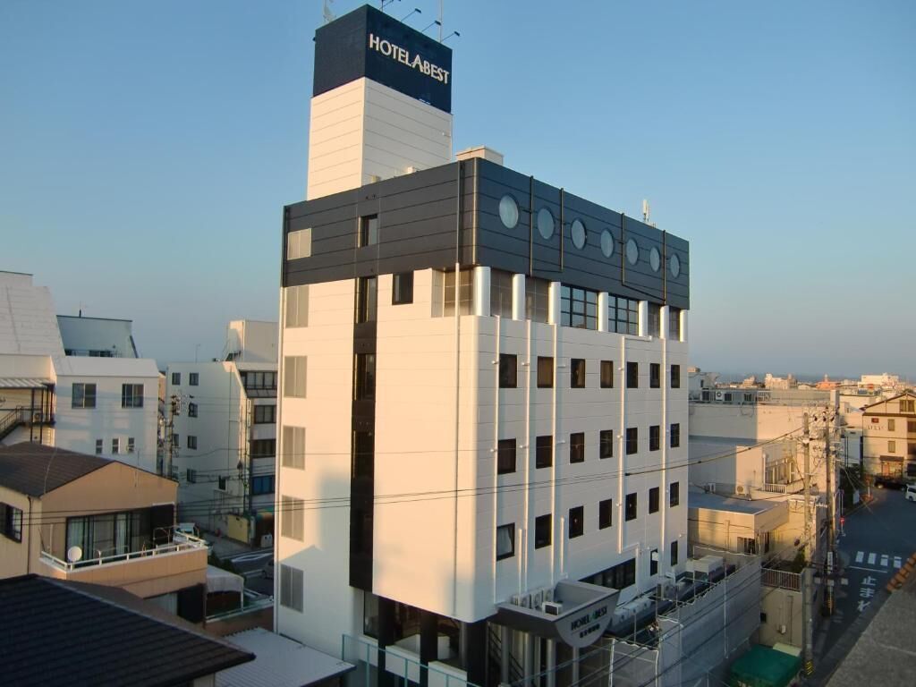 A modern hotel building with a prominent sign at the top.
