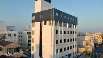 A modern hotel building with a prominent sign at the top.