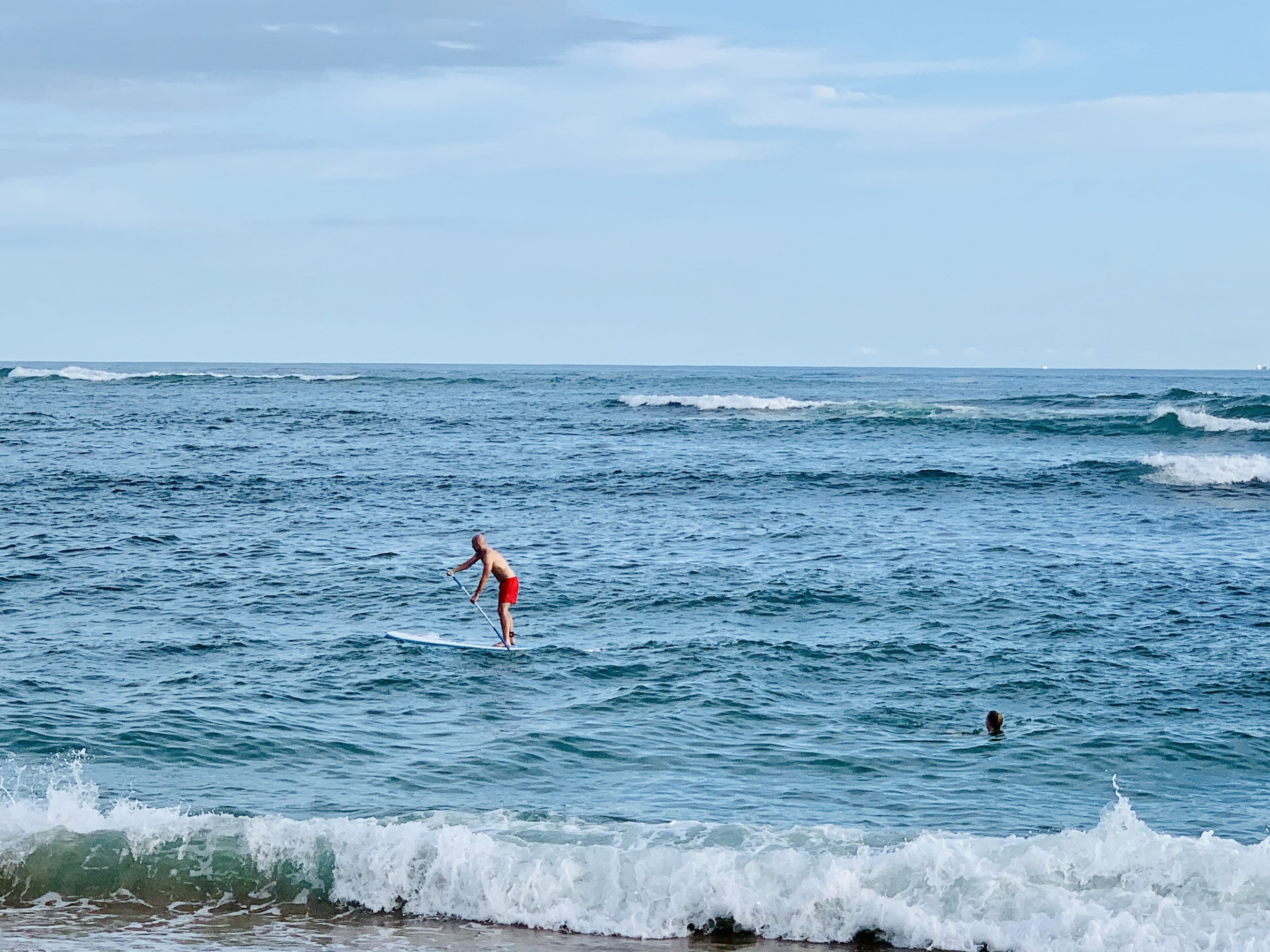 A person surfing on a wave in the ocean.