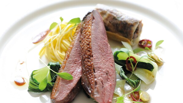 A plate of food with sliced meat, noodles, and vegetables. - Saunton Sands Hotel Source Spa and Wellness (Braunton)
