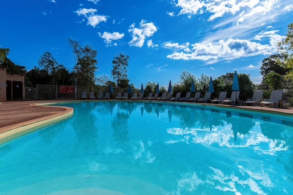 Seasonal outdoor pool, open 10:00 AM to 7:00 PM, pool umbrellas