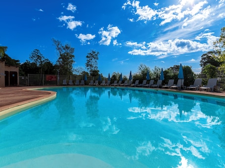 Seasonal outdoor pool, open 10:00 AM to 7:00 PM, pool umbrellas. Vacancéole - Résidence Lisa Maria