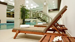 A poolside area with lounge chairs, a staircase, and a potted plant. - Earth and People Hotel & Spa (Sofia)