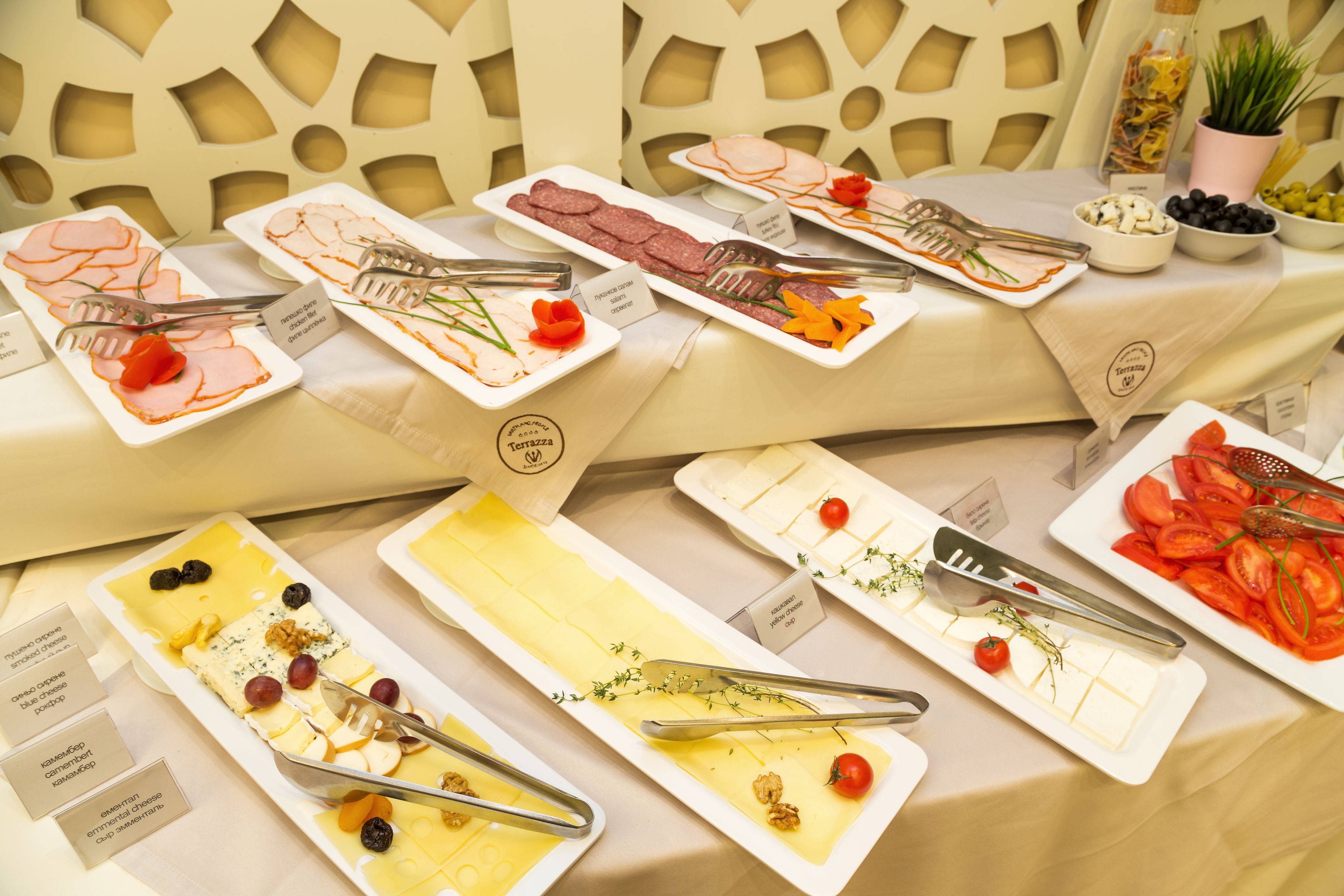 A buffet with various food items and utensils.