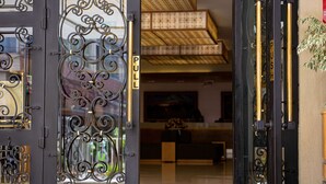 A hotel entrance with ornate black metal gates and a reception area visible through the glass doors. - Ramada Addis, Addis Ababa (Addis Ababa)