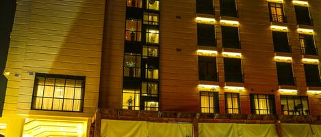 A tall hotel building with a prominent sign reading "RAMADA."