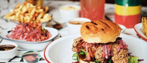 A meal with a sandwich, fries, and a drink on a table.