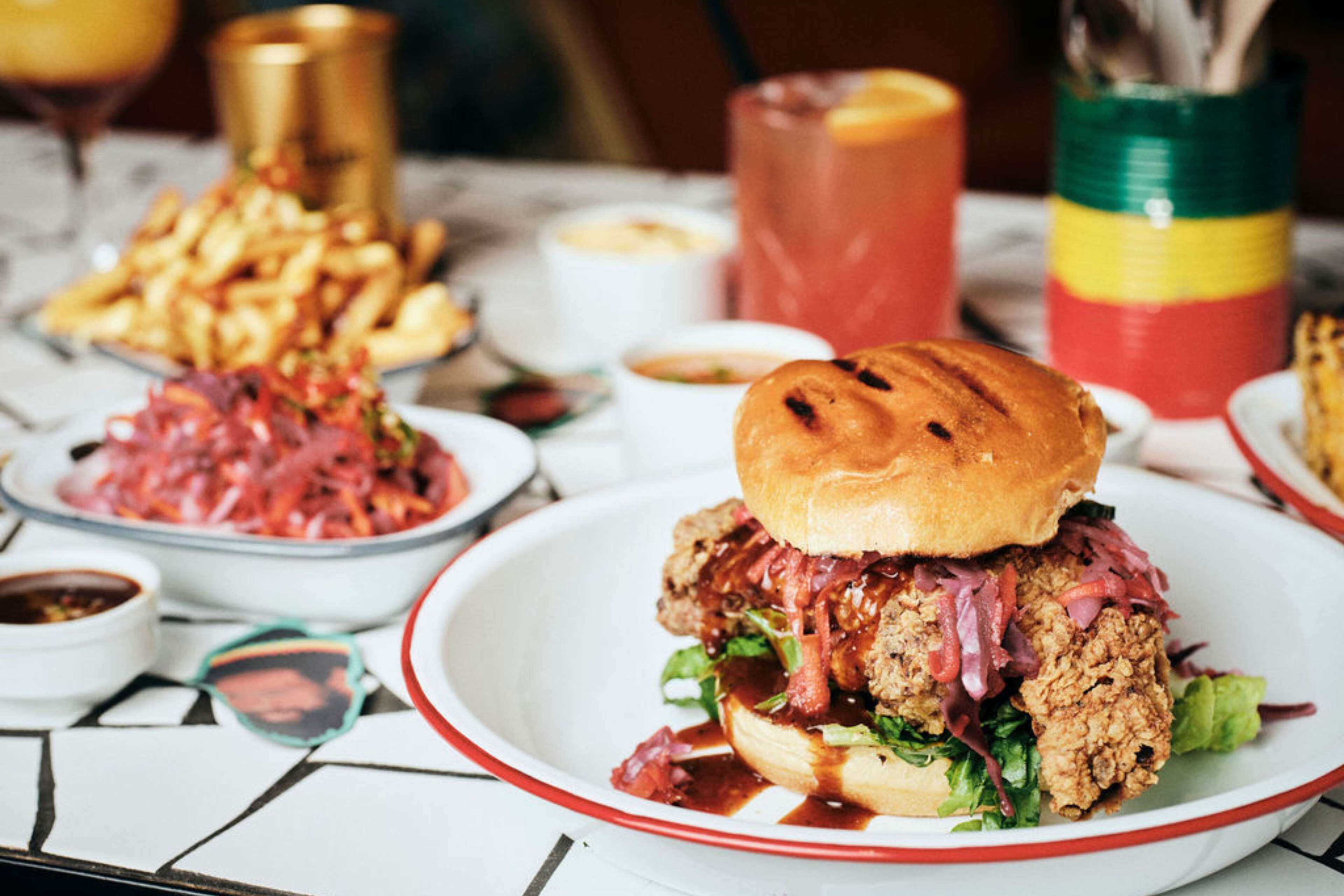 A meal with a sandwich, fries, and a drink on a table.