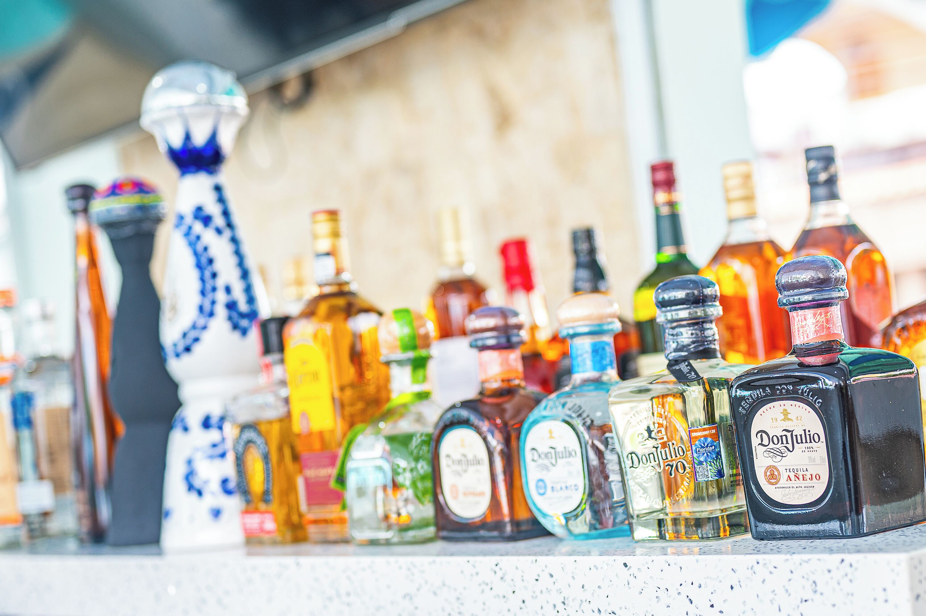 A variety of liquor bottles on a counter.