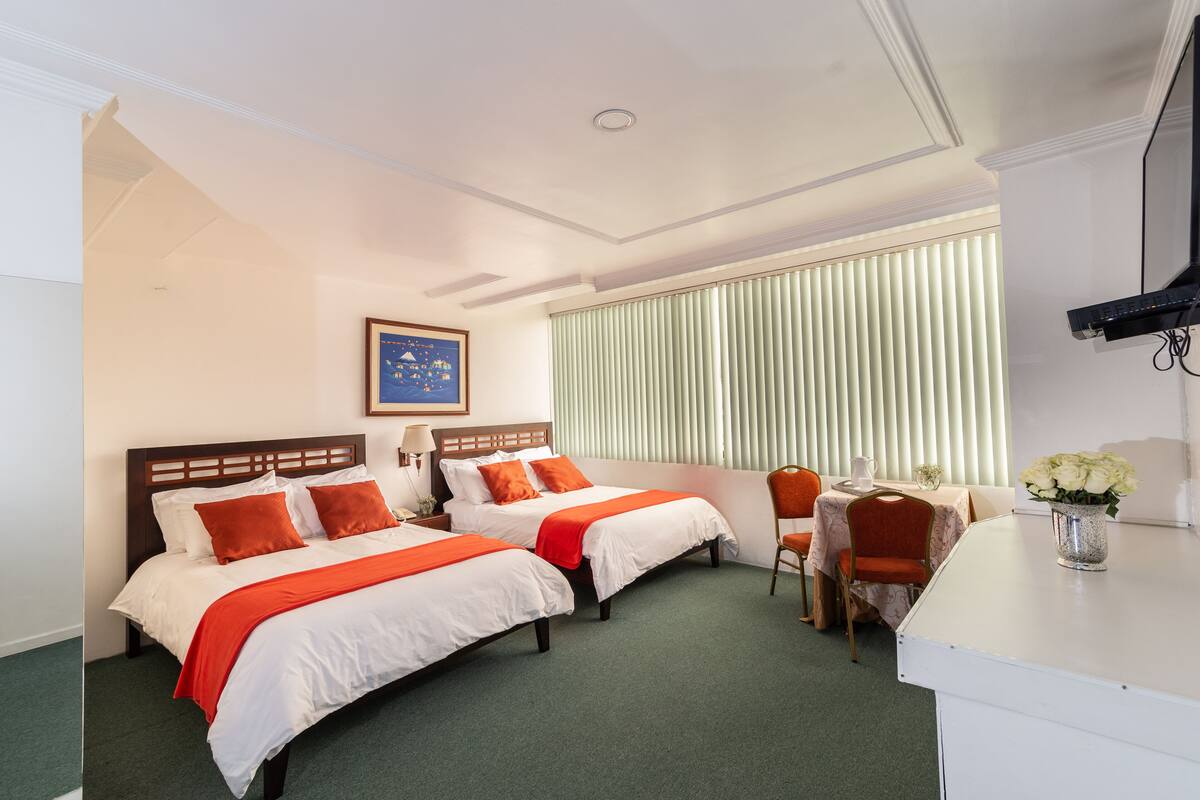 Deluxe Queen Room with Two Queen Beds | Down duvets, in-room safe, individually furnished, desk